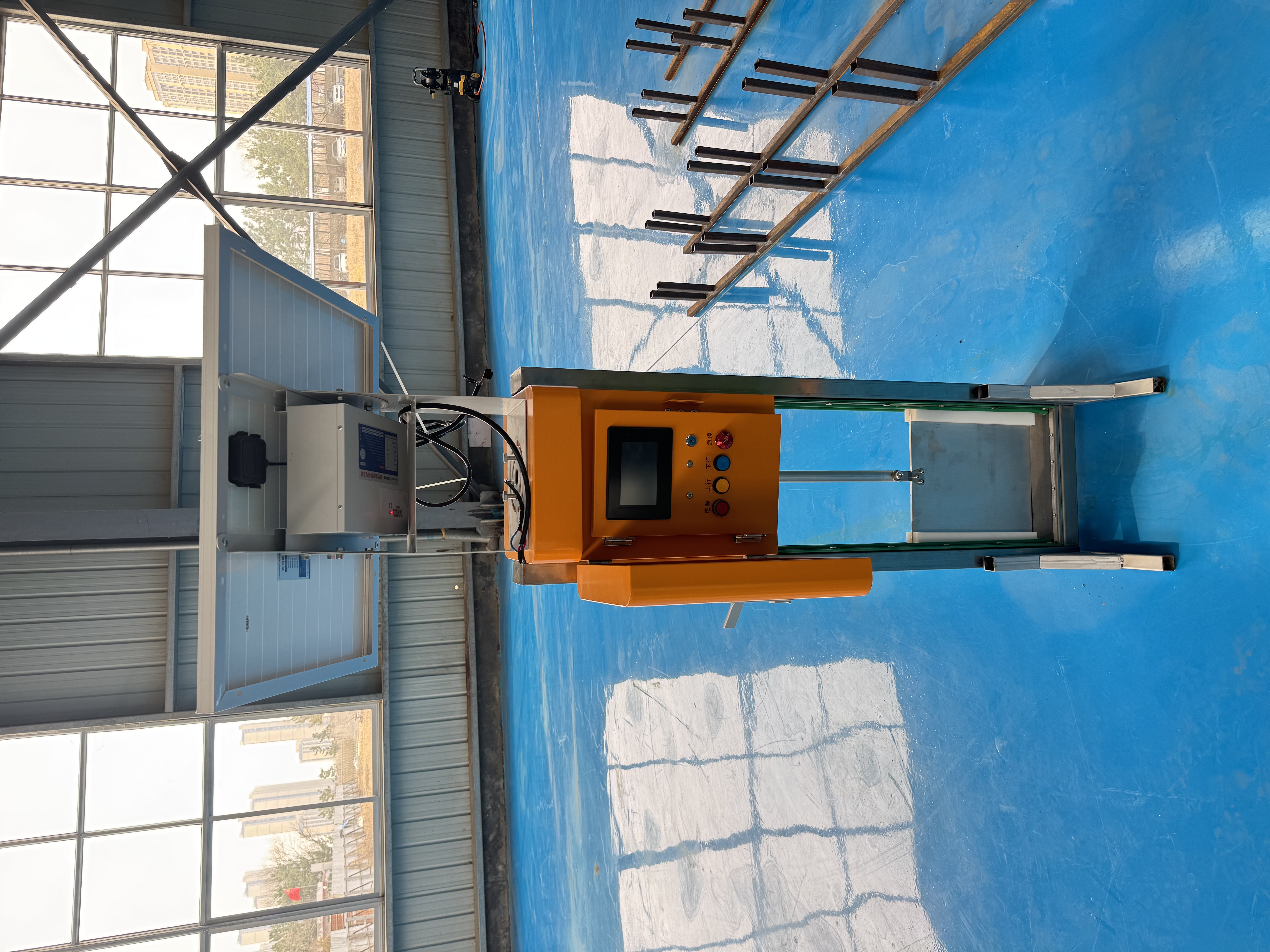 Intelligent irrigation gate with solar panel and control cabinet in a workshop